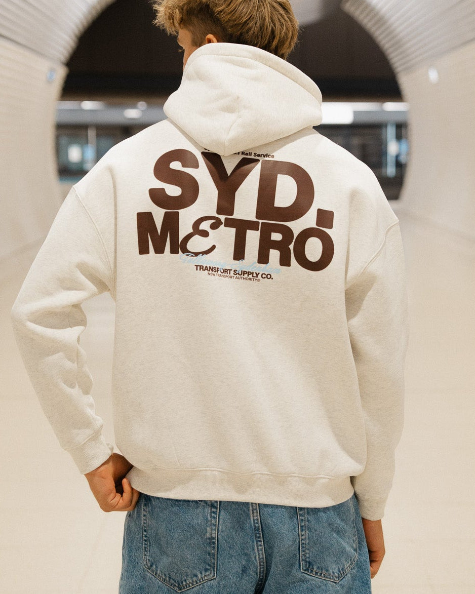 Two guys wearing a white and black sydney metro jumper on a train 