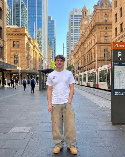 Person standing in a city street with modern and historic buildings in the background